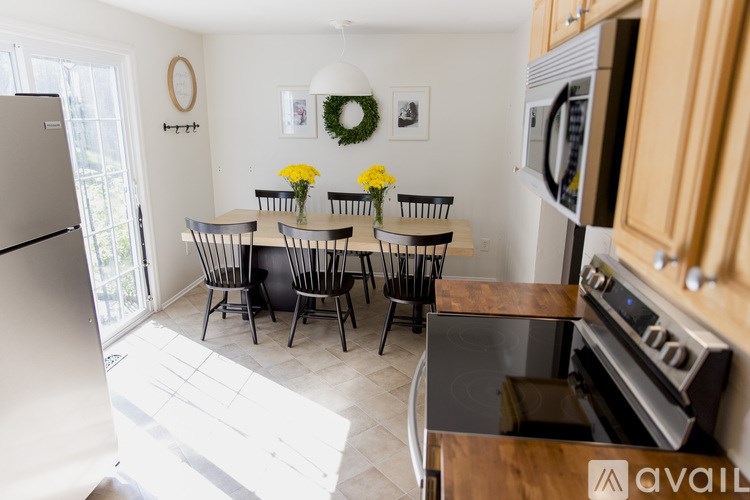 A kitchen with a table and chairs in the middle of the room.
