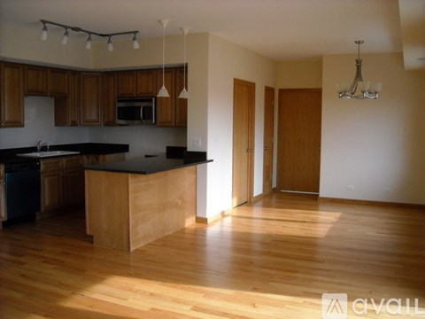 A kitchen with wooden cabinets and a black countertop.