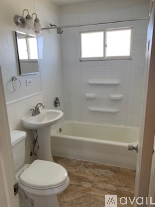 A white toilet is next to a sink in a bathroom.