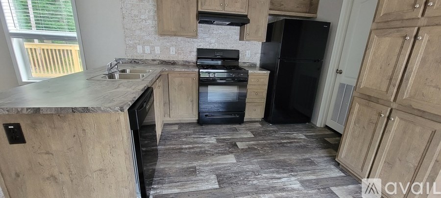 A kitchen with a black fridge and stove.