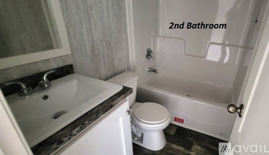 A bathroom with a toilet and a bathtub.