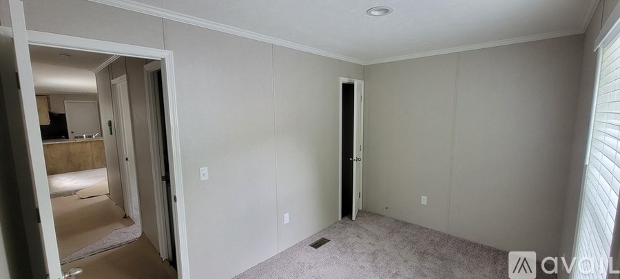 A room with a doorway leading to another room.