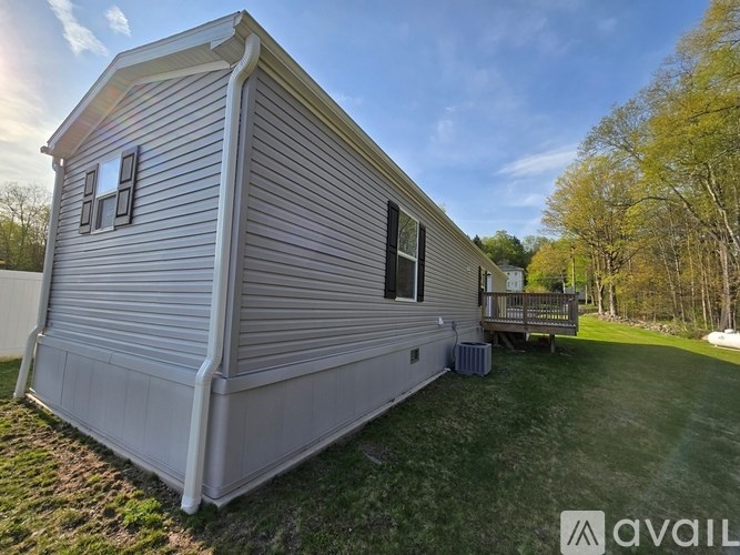 A mobile home with a deck is available for rent.