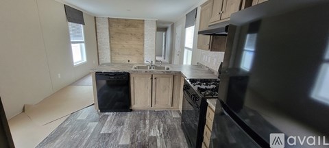 A kitchen with a black fridge and a black oven.