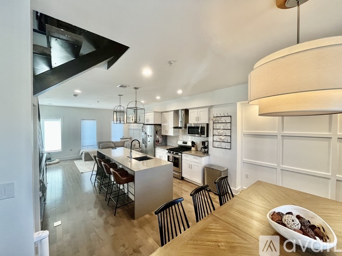 A modern kitchen with a dining table and chairs.