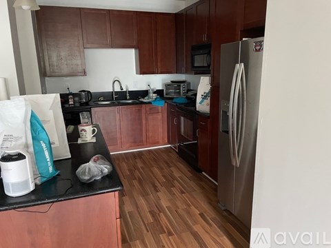 A kitchen with wooden cabinets and a white refrigerator.