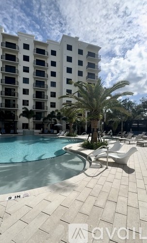 A pool area with a white building in the background.