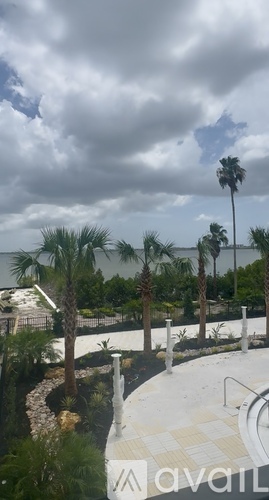 A pool area with a cloudy sky overhead.
