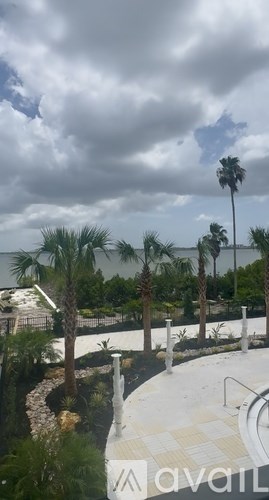 A pool area with a cloudy sky overhead.