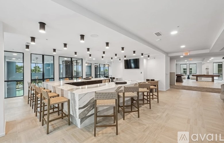 A modern kitchen with a bar area and a dining area.