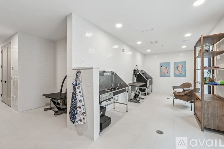 A modern kitchen with a black stove top oven and a black chair.