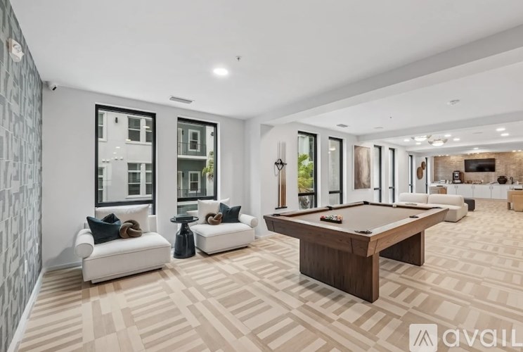 A room with a pool table and a couch.