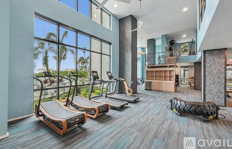 A gym with treadmills, weights, and exercise equipment.