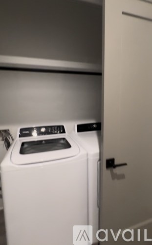 A white dishwasher is in a small kitchen.