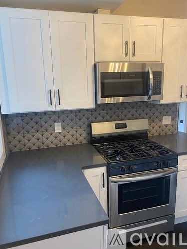 A kitchen with a stove and cabinets.
