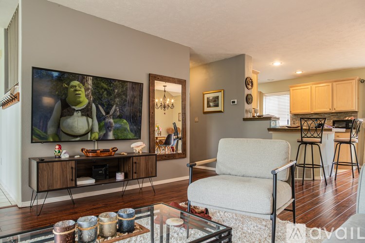 A living room with a Shrek painting on the wall.