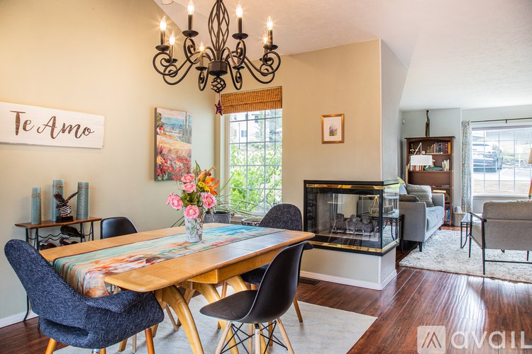 A dining room with a wooden table and chairs.