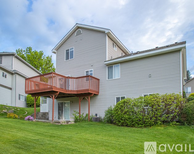 A house with a red deck and a balcony.