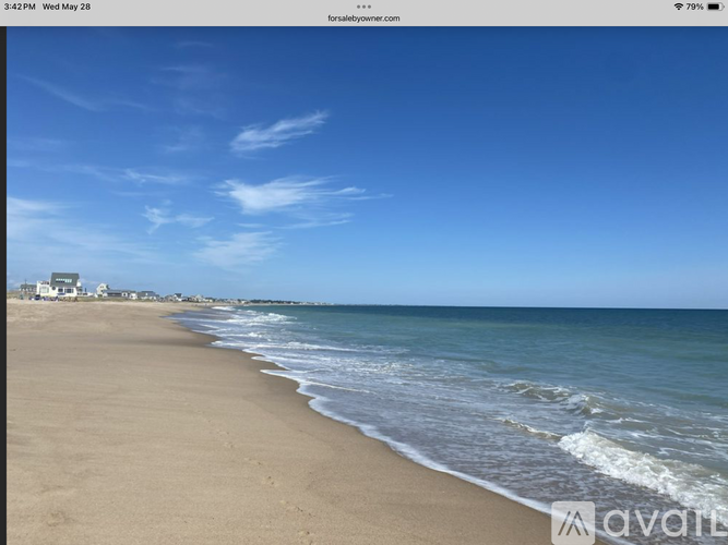 A beach with waves coming in from the ocean.