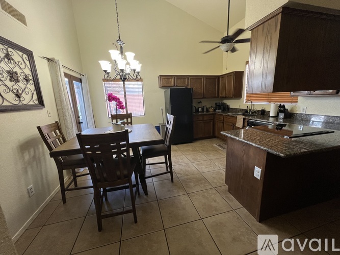 A kitchen with a table and chairs in the middle of the room.