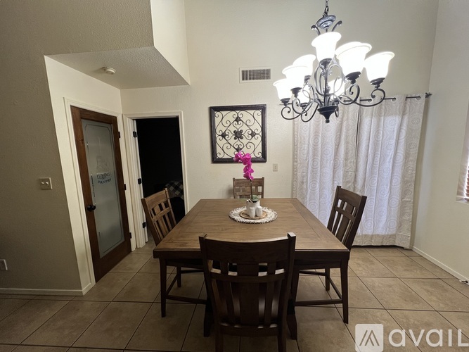 A dining room with a wooden table and chairs.