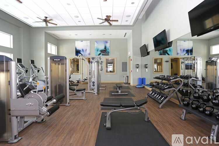 A gym with a variety of equipment including weights and machines.
