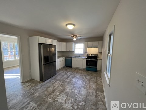 A kitchen with a refrigerator, stove, and oven.