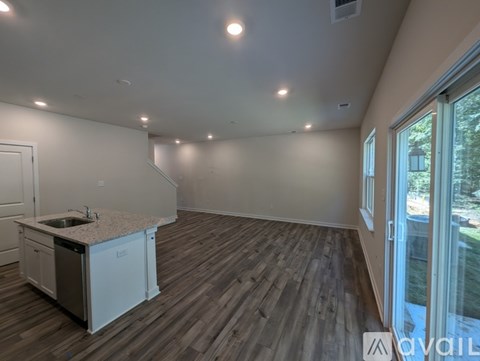 A kitchen area with a sink and cabinets is available for rent.