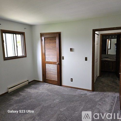 A room with a Galaxy S23 Ultra phone on the floor.
