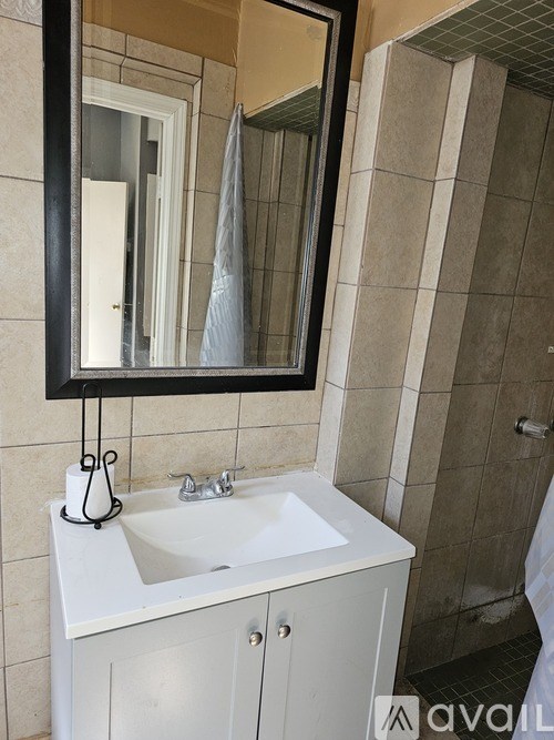 A white sink vanity with a mirror above it.