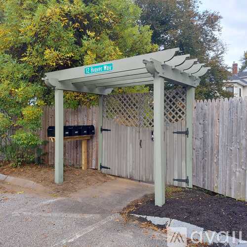 A wooden fence with a sign that says "AVAILABLE" on it.
