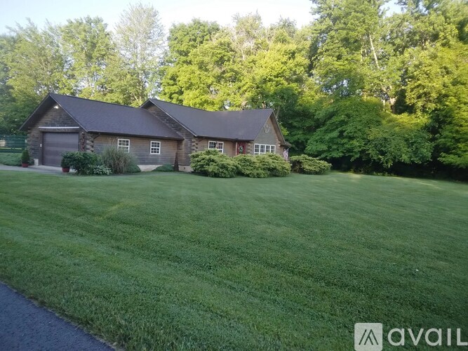 A house with a large lawn in front of it.