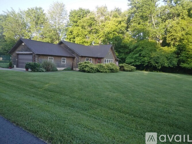 A house with a large lawn in front of it.