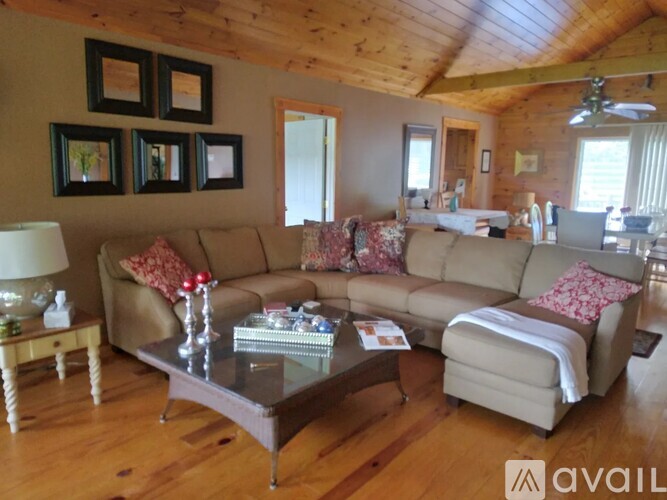 A living room with a couch, coffee table, and pictures on the wall.