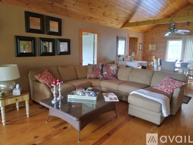 A living room with a couch, coffee table, and pictures on the wall.