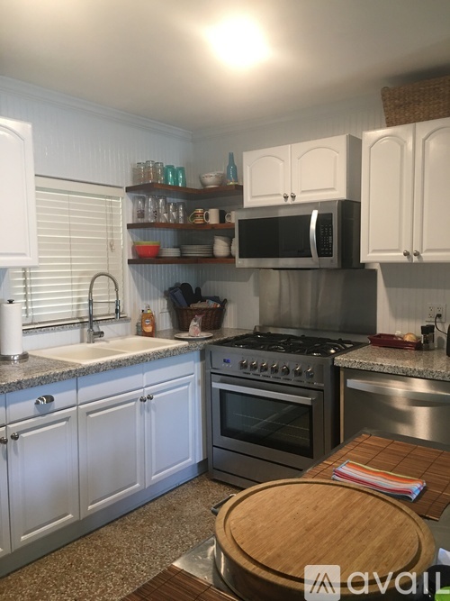 A kitchen with a stove top oven and a microwave above it.