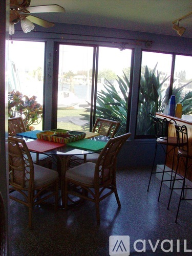 A dining room with a table and chairs.
