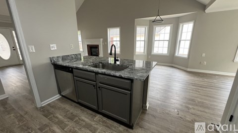 A kitchen with a granite countertop and a sink.