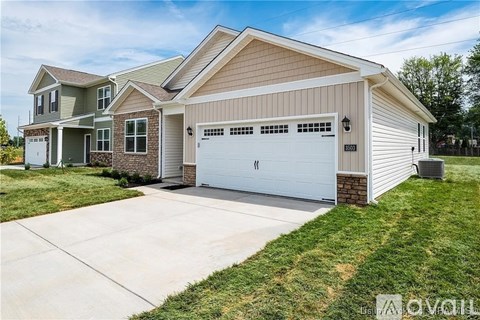 A two-story house with a garage is for sale.