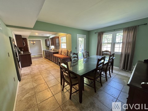 A kitchen with a table and chairs in the middle of the room.