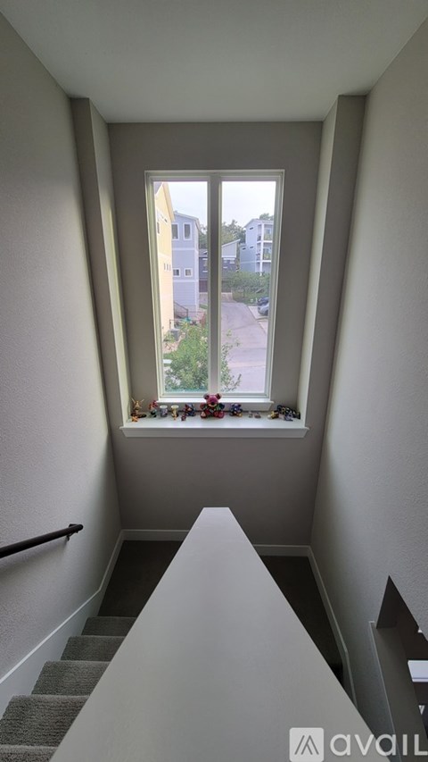 A window with a view of a street and buildings outside.