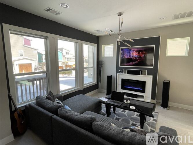 A living room with a grey couch and a television.