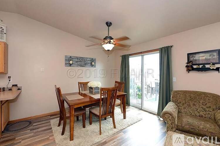 A dining room with a table set for four.