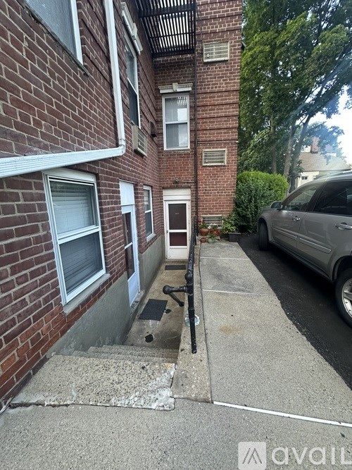 A brick building with a car parked in front.