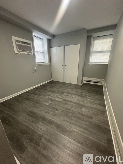A room with grey walls and a wooden floor.