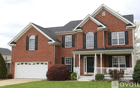 A brick house with a black door and windows.