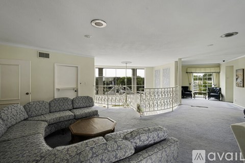A living room with a grey sofa and a wooden coffee table.