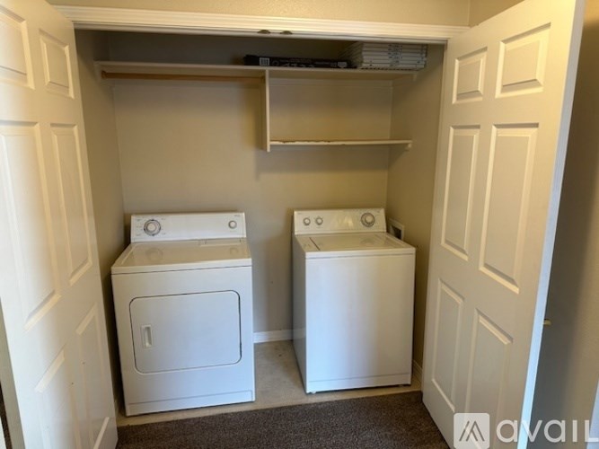 A small laundry room with a washer and dryer.