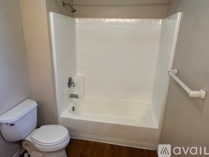 A white bathroom with a toilet and a bathtub.