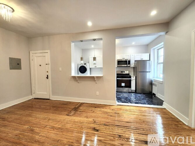 A room with wooden floors and a white door.